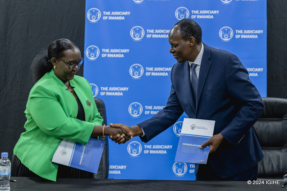 The New Chief Justice Domitilla Mukantaganzwa with his predecessor, Dr. Faustin Ntezilyayo at the handover ceremony on Thursday.