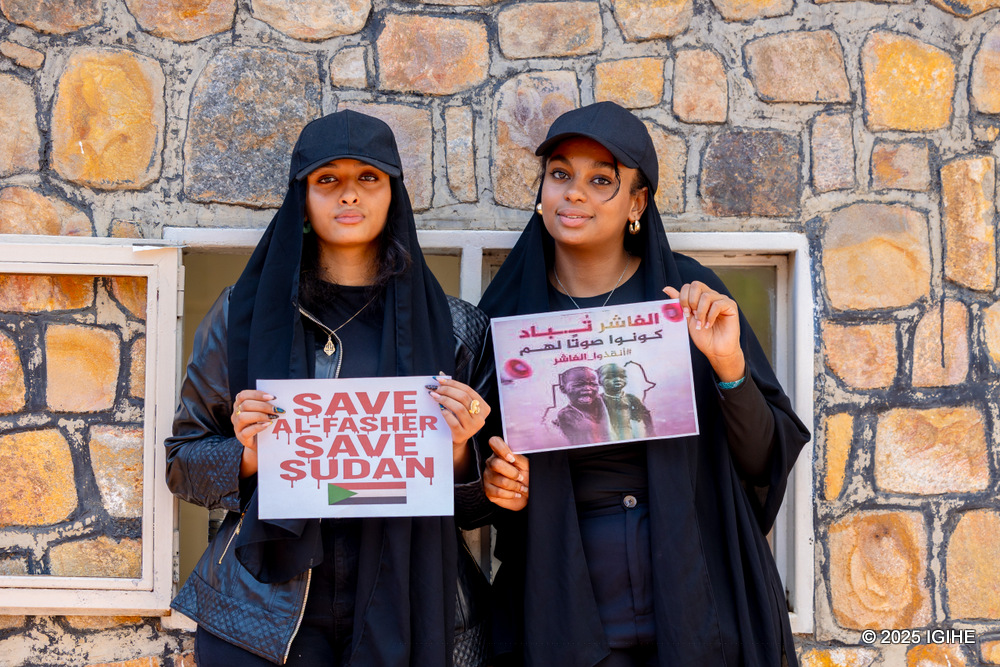 Sudanese nationals in Rwanda hold signs condemning the ongoing killings in El Fasher by the Rapid Support Forces (RSF).