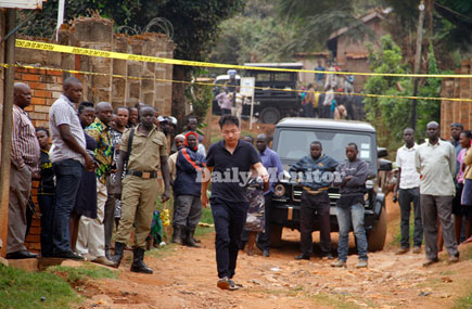A Chinese official arriving at the crime scene in Kikoni - Makerere.