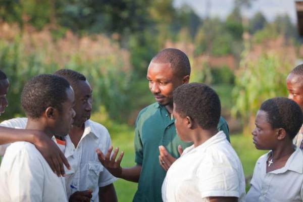 Rolex Laureate Dr. Olivier Nsengimana, center, and fellow Rwandans discuss the plight of the gray-crowned crane 