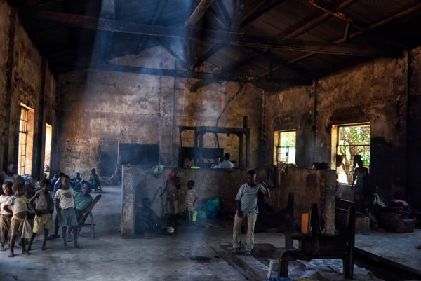 Members of the Bambote ethnic group in an abandoned cotton factory in Nyunzu, Democratic Republic of Congo. The Bambote are forest dwellers who have been displaced by one of the many violent conflicts in Congo.