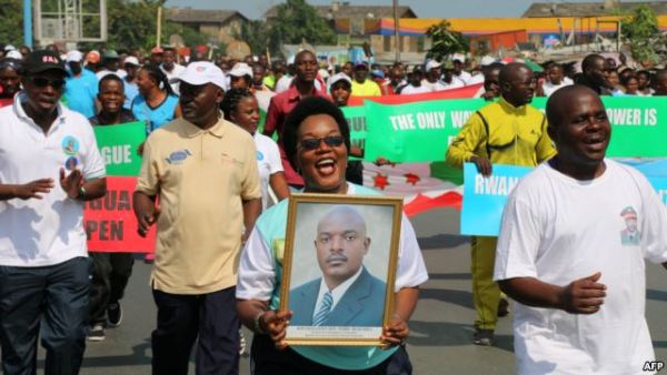 A woman holds up a picture of Burundi's President Pierre Nkurunziza during a rally in Bujumbura on May 14, 2016, commemorating the one-year anniversary of the failed attempt of a government coup.