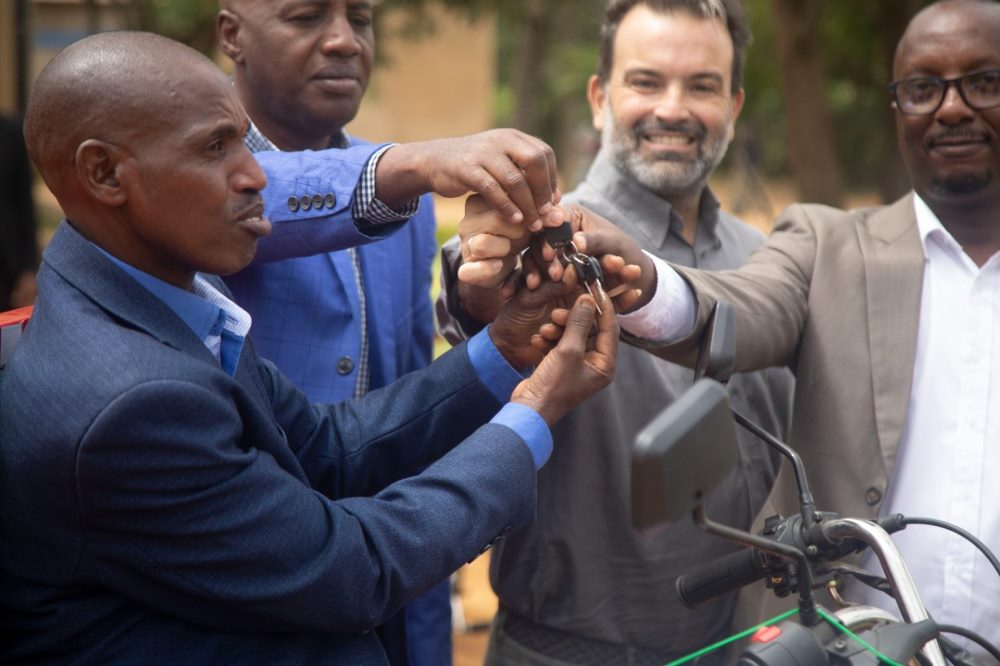 Donors handing over the key to beneficiaries. 