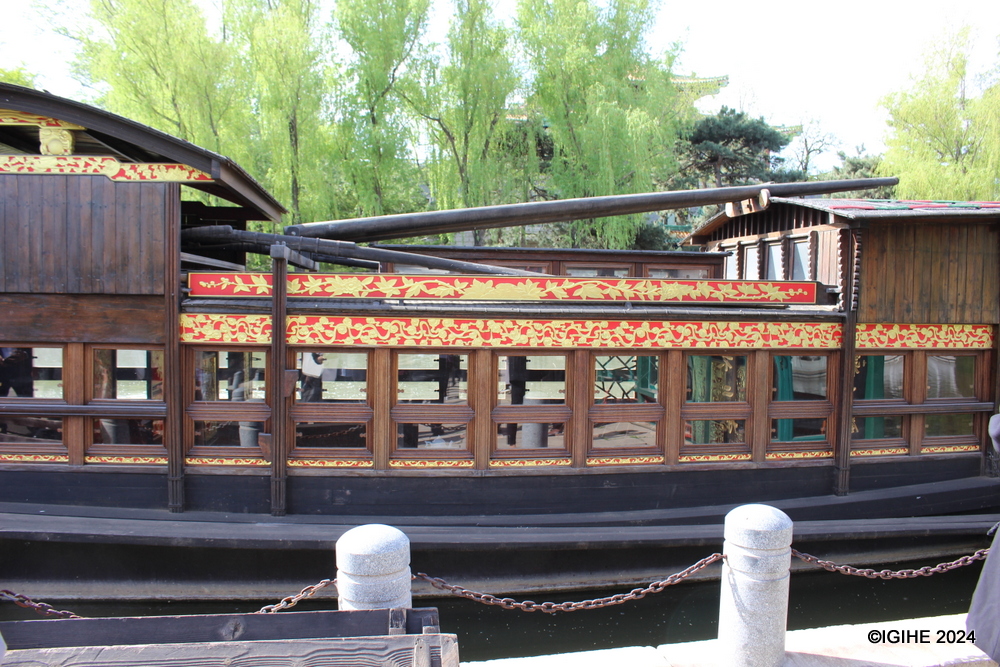Placed on Luoyan Lake, the red boat complements a striking red sculpture, adding to the picturesque and historically resonant landscape.