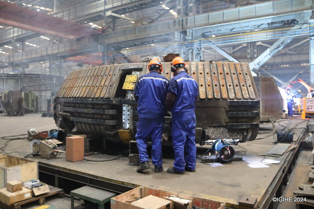 A close-up view of the intricate assembly process of a Tunnel Boring Machine, highlighting the precision and teamwork of CCCC Tianhe's skilled workers.