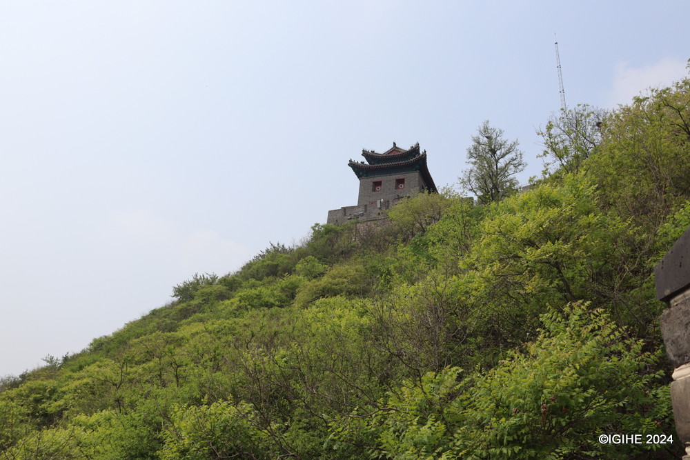 Nestled among expansive mountain ranges, the Great Wall stretches impressively.