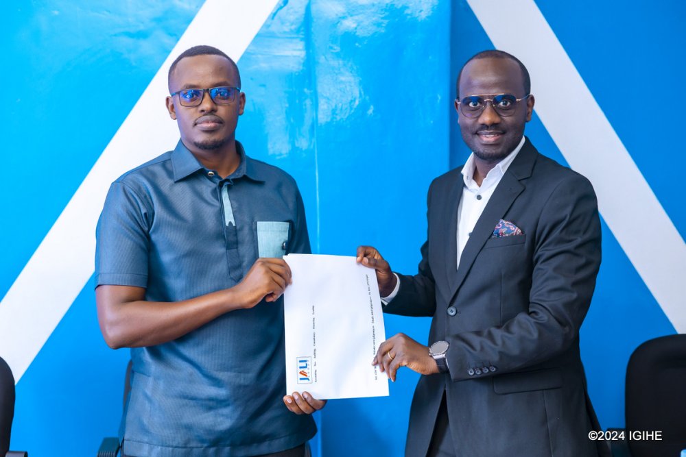 The CEO of Jali Finance, Felix Nkundimana (right) with the CEO of Koi Pay, Frank Mugisha after signing the acquisition agreement.