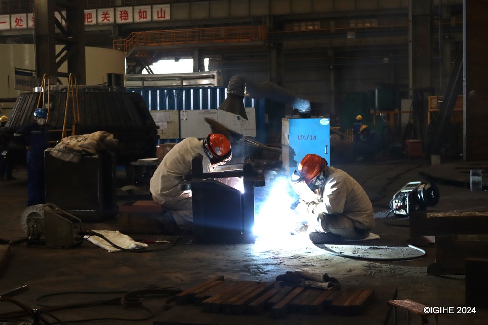 Workers meticulously welding TBM components, a testament to the human skill and dedication behind each machine produced by CCCC.