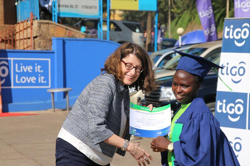 Millicom vice president , Cynthia Gordon with a student