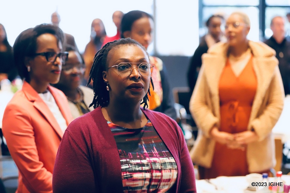 Sophia Mukamana van Heesewijk with other participants of the event as they sand the National Anthem. 