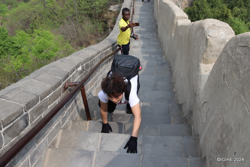 Climbing the Great Wall demands determination. Here, a tourist gracefully ascends the stairs at Juyongguan Great Wall with cat-like precision