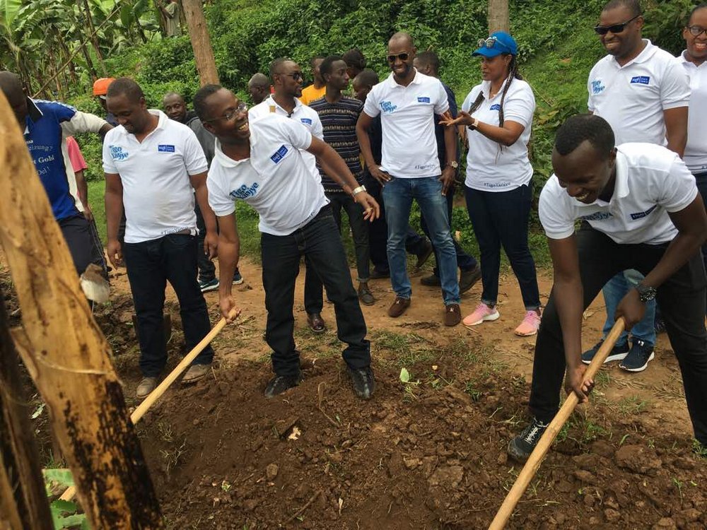 Tigo CEO, Philip Amoateng (Center) joins staff in Community Work (Umuganda)