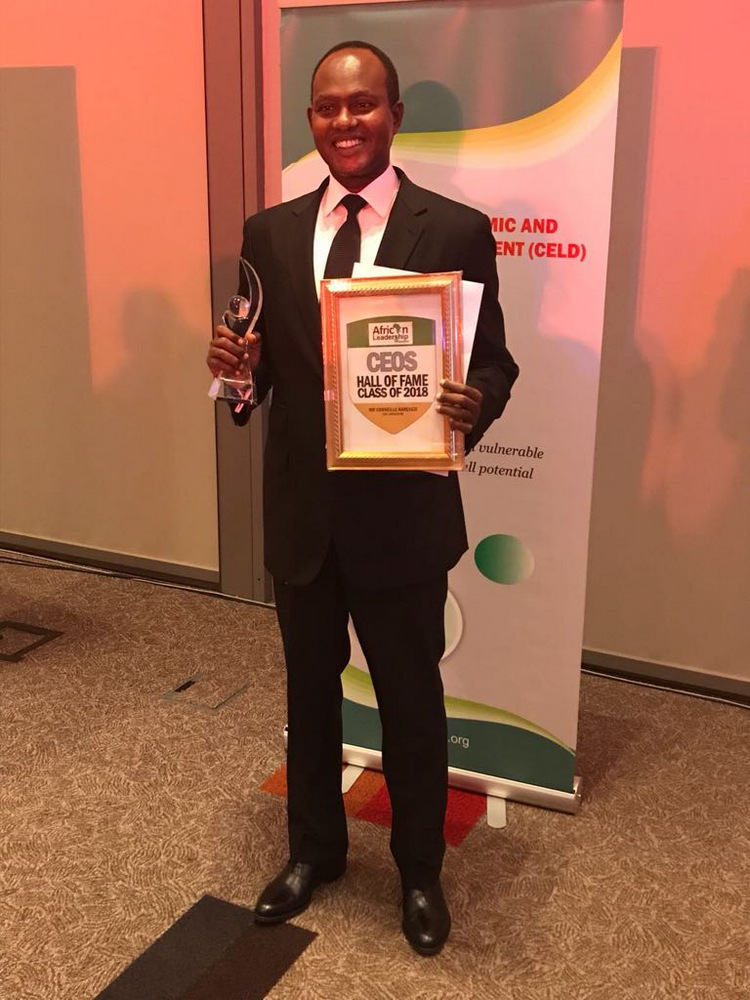 Corneille Karekezi holding his Business Excelllence Award