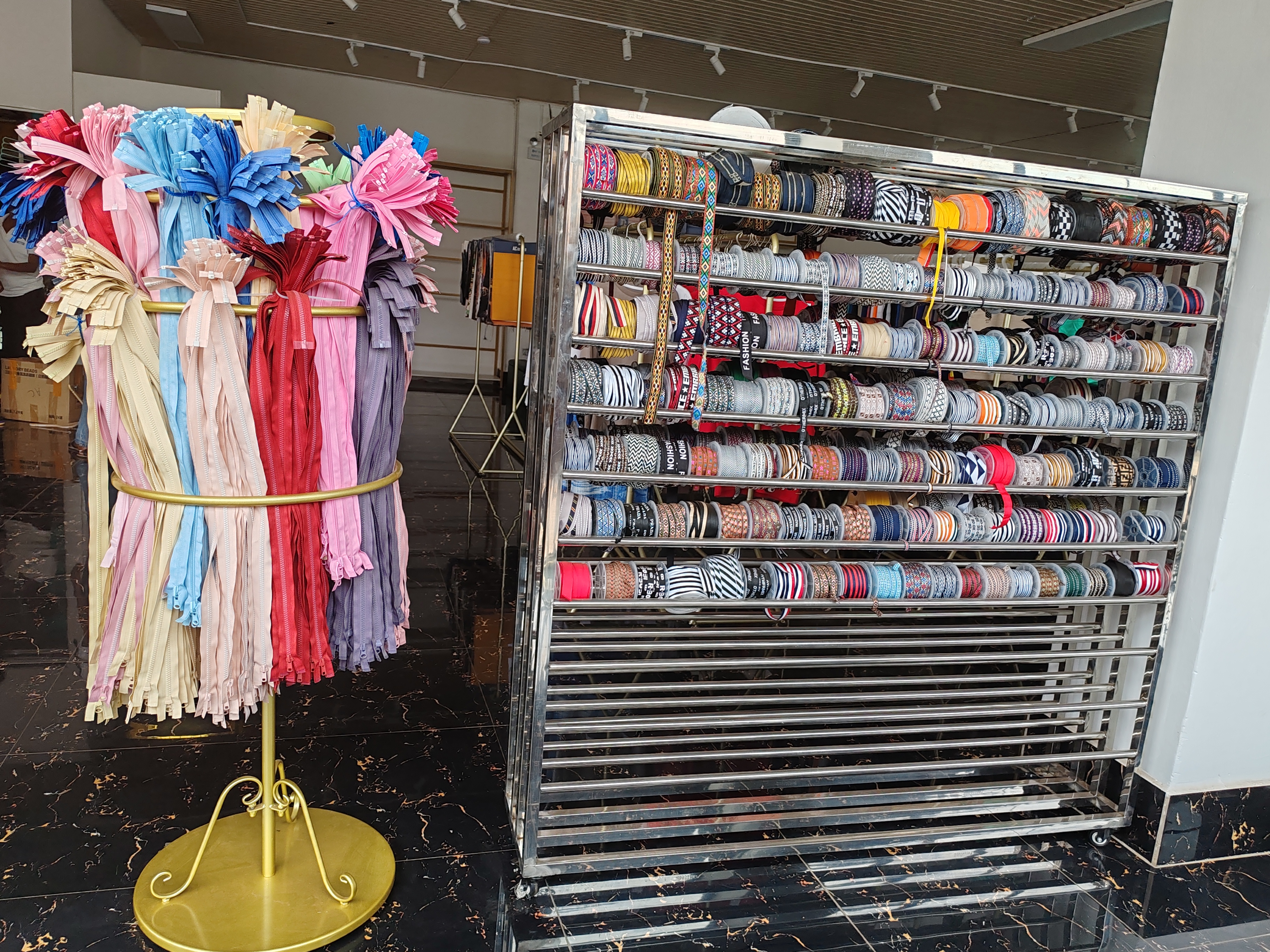 Local consumers are provided with a wide range of textile fabrics, sewing machines, and essential accessories such as buttons and zippers.