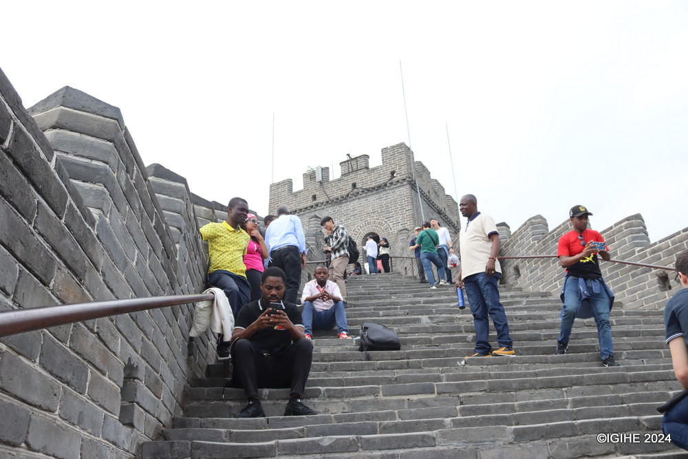 Despite the arduous trek, tourists persistently make their way to the top watchtower of the Great Wall.