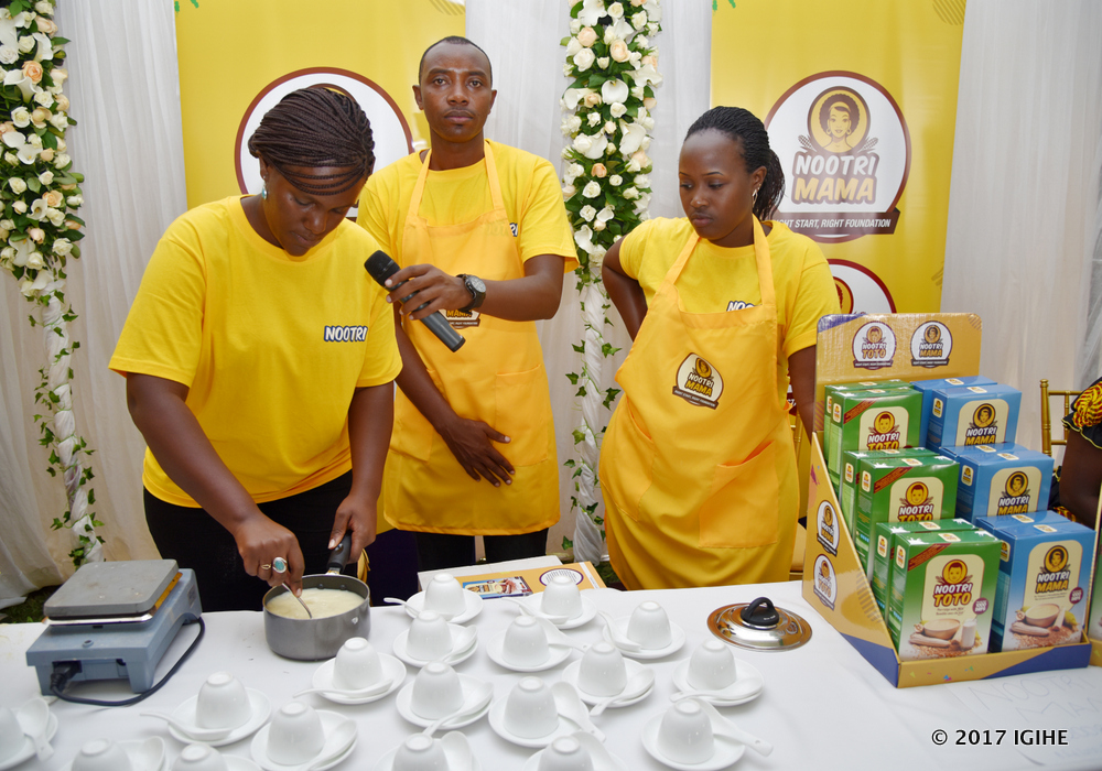 AIF employees explaining how to prepare porridge from 'Nootri Mama and Nootri Toto' flours recently during the celebration of Mother's Day. 