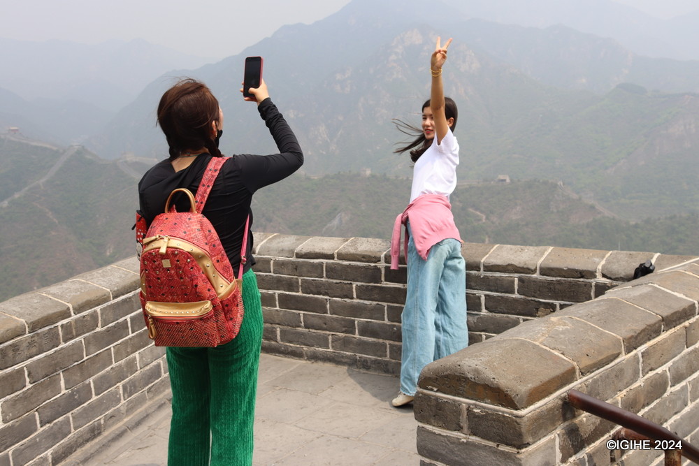 Arduous trek does not refrain visitors from taking photos of souvenirs.
