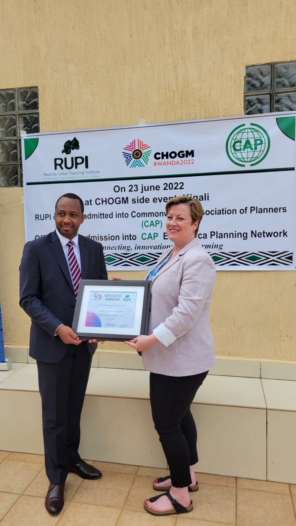 CAP Secretary-General, Kelley Moore presenting the certificate of membership to the President of RUPI, Vivien Munyaburanga. 