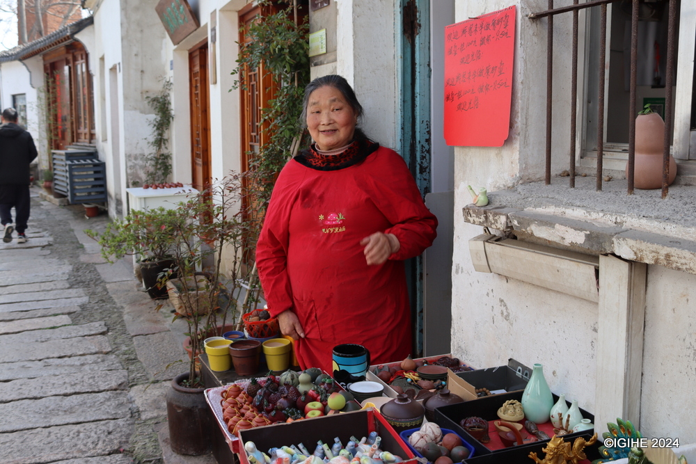 An old woman at the artisanal village waiting for clients to buy her handicrafts.