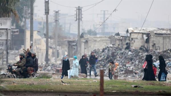 Civilians carry their belongings as they flee deeper into the remaining rebel-held areas of Aleppo