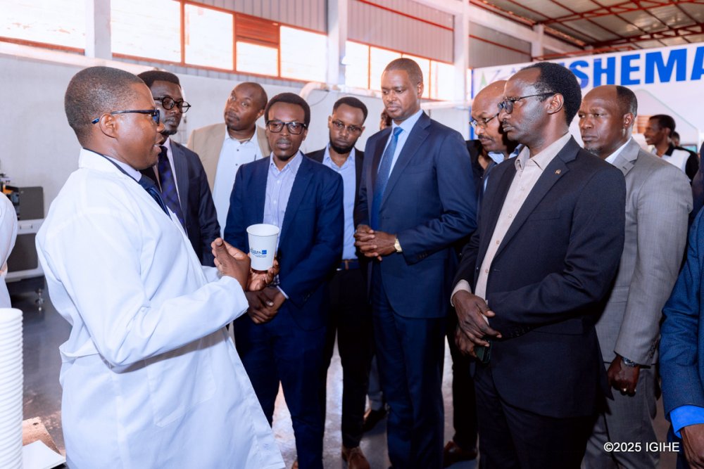 Officials tour A-ZF Global Trading’s plant to learn about its paper cup production process.