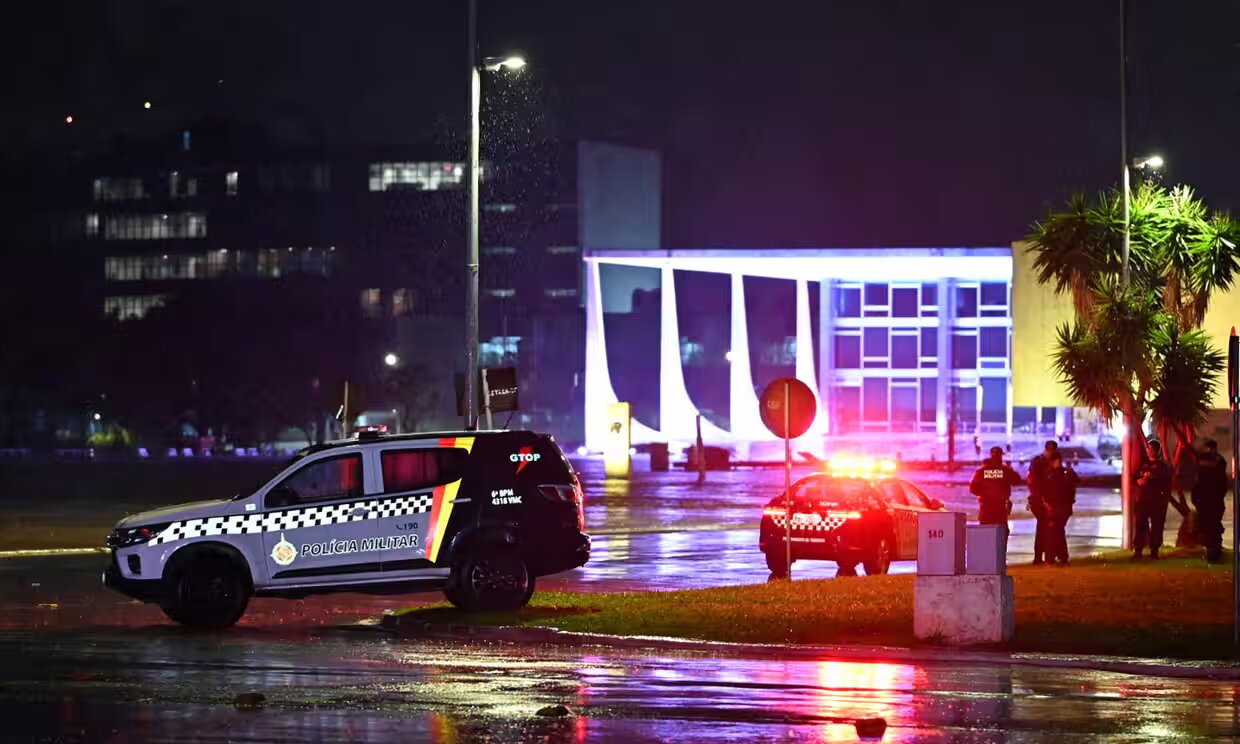 Police vehicles are seen in front of the Brazilian Supreme Court after explosions in the Three Powers Square in Brasilia ahead of the G20. 