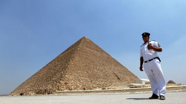 A policeman stands guard in front of the Pyramid of Khufu, the largest of the Great Pyramids of Giza, on the outskirts of Cairo, Egypt, August 31, 2016.