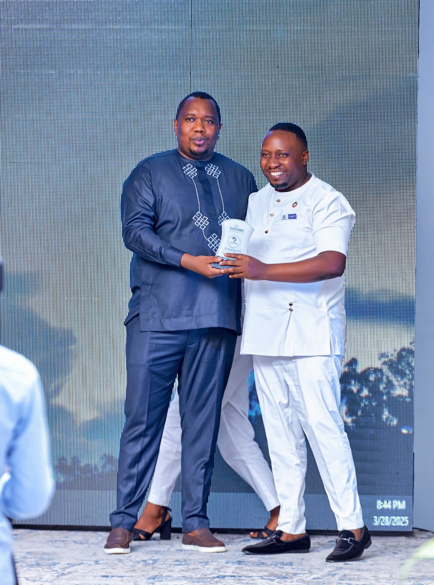 Dr. Francis Habumugisha receives the award won by Mega Global Market.