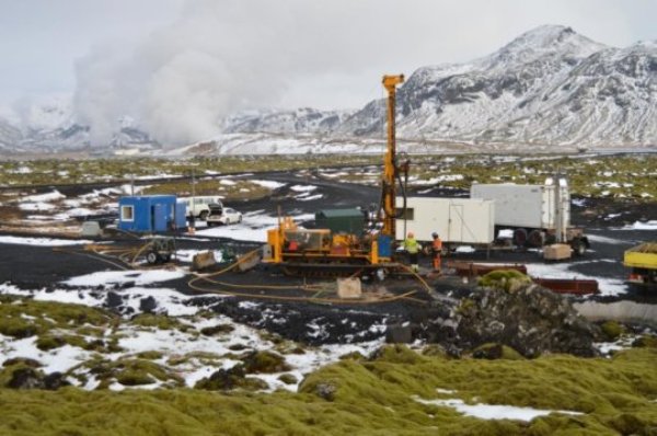 CarbFix I pilot CO2 injection site during wireline diamond drilling to recover a 150 m of core from the CO2 storage reservoir in 2014 (~2 years after CO2 injection). Steam emissions from the Hellisheidi geothermal powerplant are visible in the background.