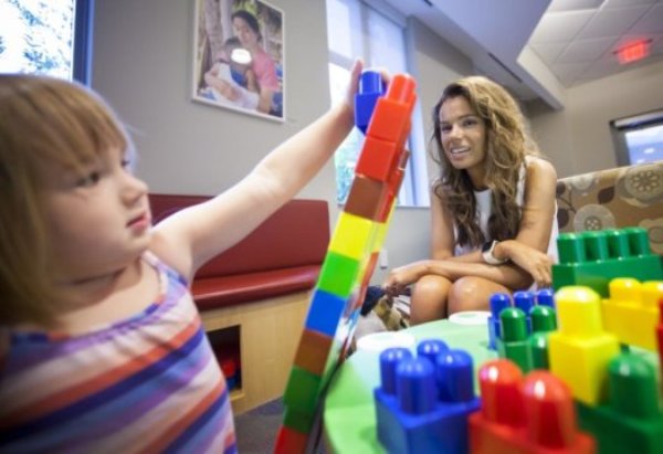 "Our work may contribute to the understanding of the nature of mathematics," says Emory University psychologist Stella Lourenco, shown meeting with a young visitor to the Emory Child Study Center.