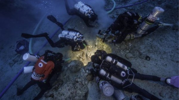 Archaeologists Brendan Foley, Theotokis Theodoulou and Alex Tourtas excavate the Antikythera Shipwreck skeletal remains, assisted by Nikolas Giannoulakis and Gemma Smith.