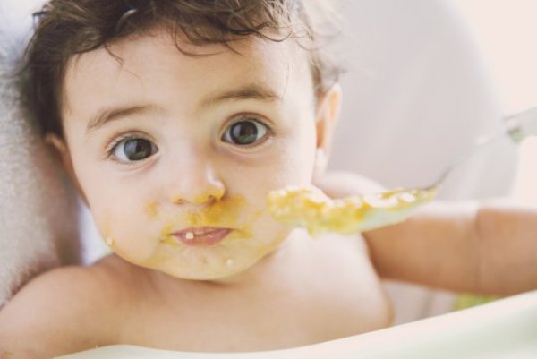Baby eating. Feeding children egg between the ages of four and six months may reduce their risk of developing egg allergy, new research suggests.