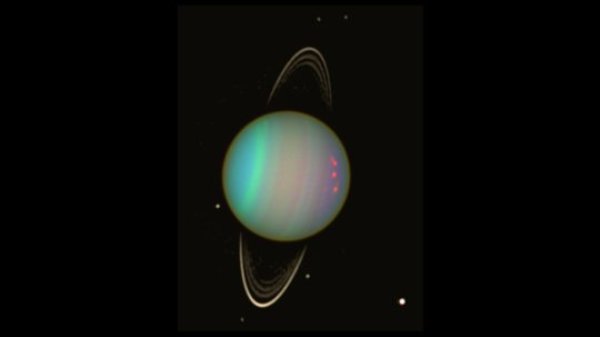 Uranus is seen in this false-color view from NASA's Hubble Space Telescope from August 2003. The brightness of the planet's faint rings and dark moons has been enhanced for visibility.