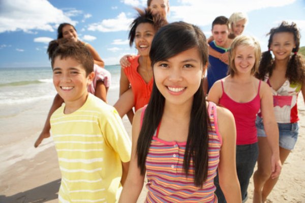 Teens at the beach. Researchers found that an increase in UVB exposure at age 14 to 19 years and 20 to 39 years was associated with reduced odds of myopia.