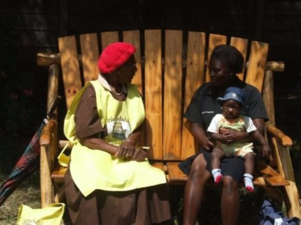 A lay health worker or community 'Grandmother' conducting a problem solving therapy session with a patient on the Friendship Bench.