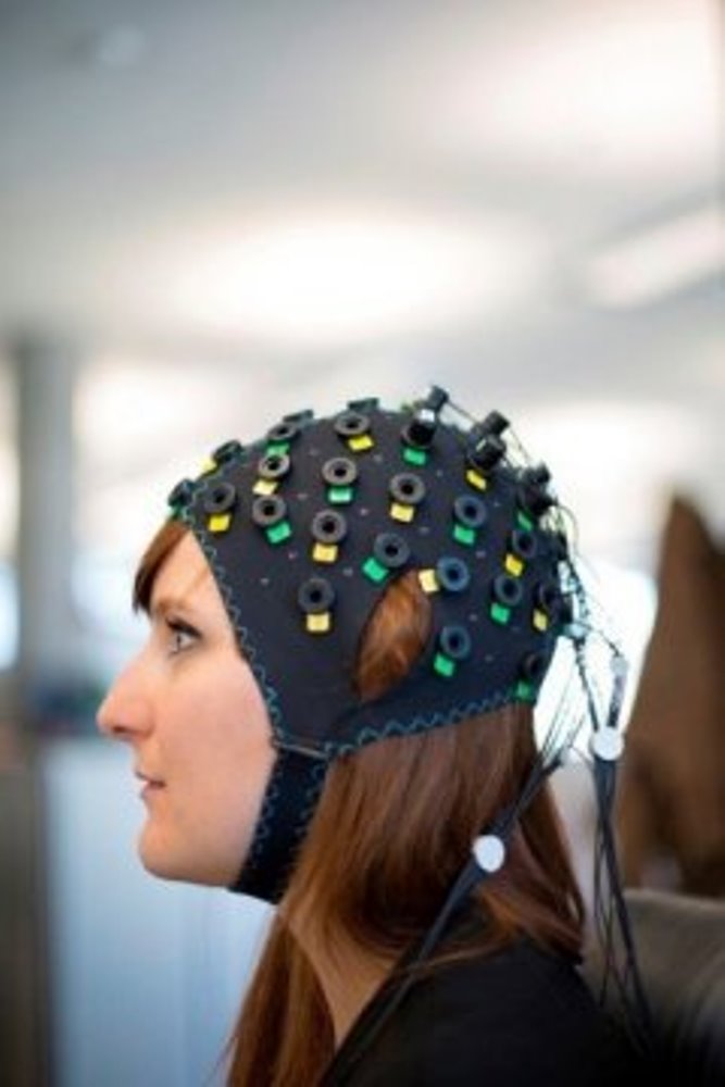The NIRS/EEG brain computer interface system shown on a model.