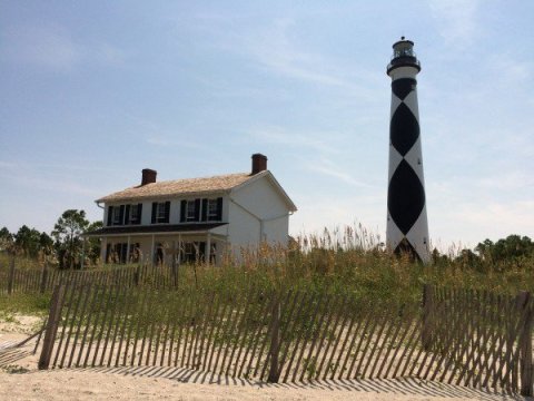The Cape Lookout lighthouse and 1873 keeper's dwelling on the Outer Banks of North Carolina.