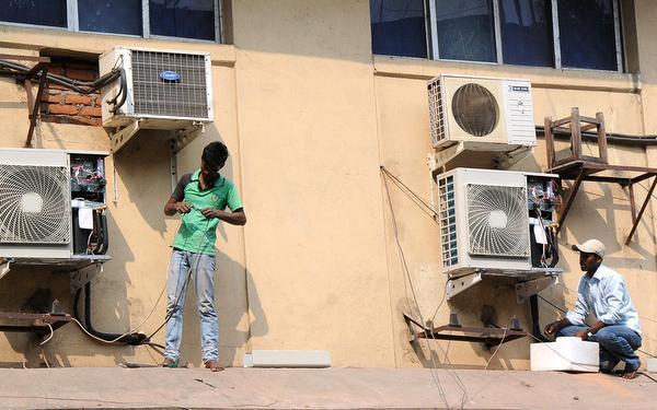 COOLING PERIOD: “The deal allows India’s heating, ventilation and air conditioning sectorto grow while giving time to refrigerant manufacturers to shift to alternatives.” Service men repairing AC units in Hyderabad.