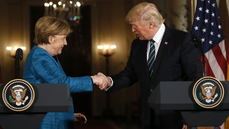 Trump and Merkel shake hands at the conclusion of their joint news conference