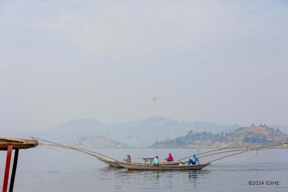 Locals fishing in the serene waters of Lake Ruhondo.