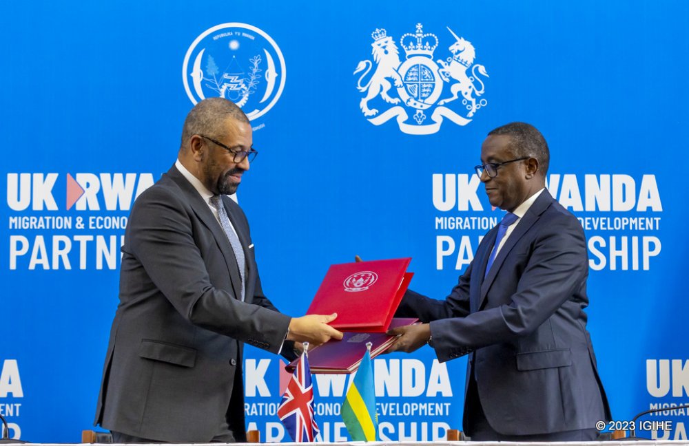 The Minister of Foreign Affairs, Dr. Vincent Biruta exchanging documents with UK Home Secretary, James Cleverly after signing the revised migration treaty in Kigali last year.