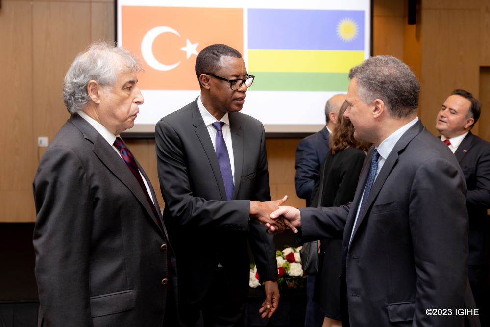 Rtd Gen James Kabarebe, the Minister for Foreign Affairs in charge of Regional Cooperation exchanging greetings with French Ambassador to Rwanda, Antoine Anfré.  