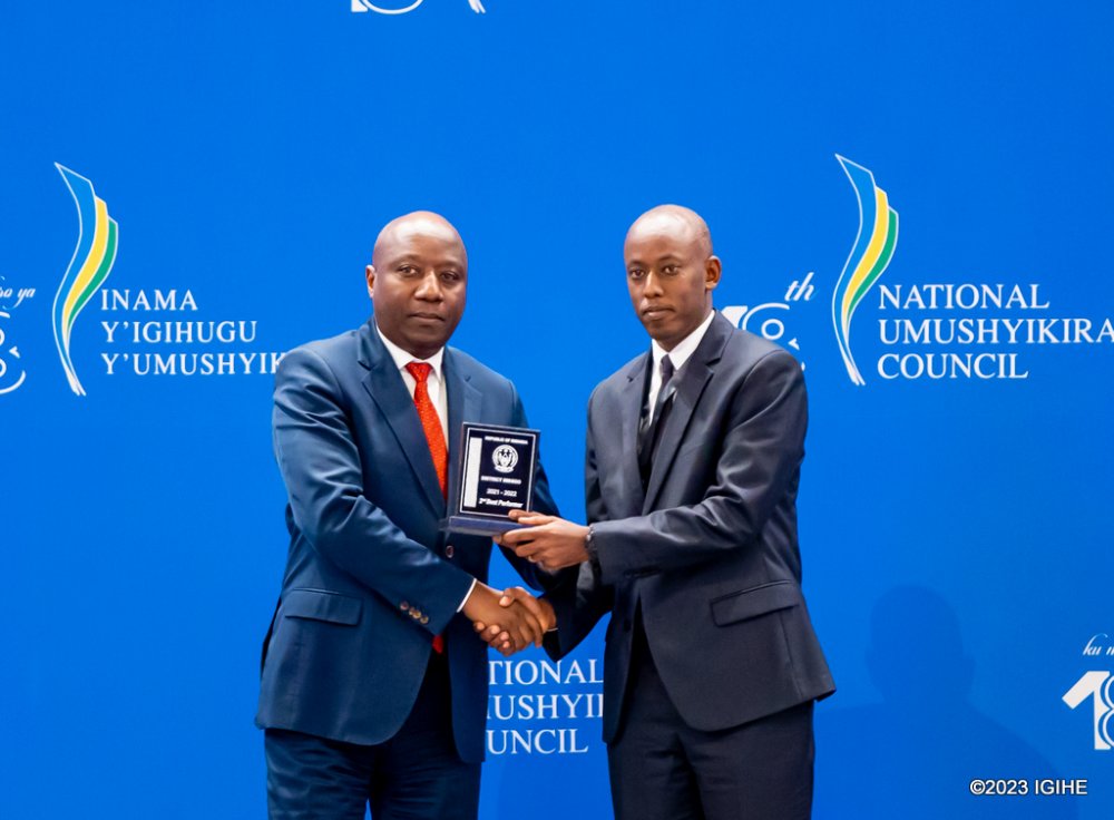 The Mayor of Huye, Sebutege Ange (right) receiving the award for second place. 