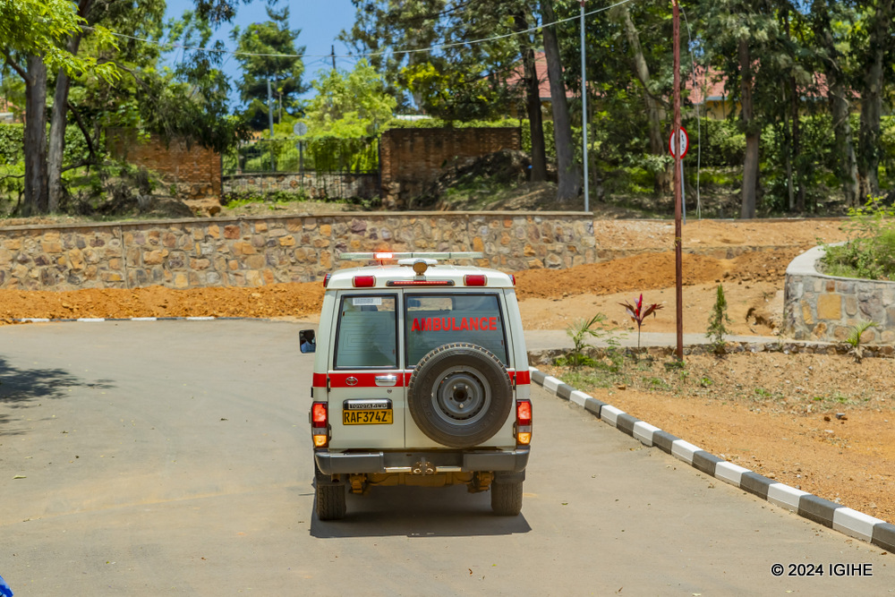 An ambulance carrying injured individual after receiving first aid.  