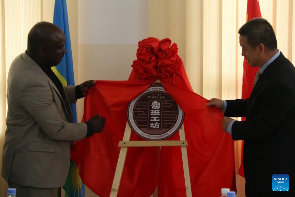 Chinese Ambassador to Rwanda Wang Xuekun (R) and Governor of Rwanda's Northern Province Maurice Mugabowagahunde unveil the name plate of the Luban workshop at IPRC Musanze in northern Rwanda, Nov.18, 2023. (Photo by Huang Wanqing/Xinhua)