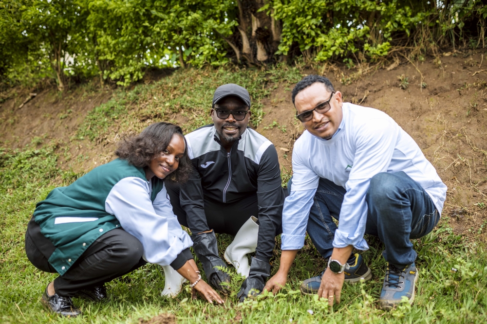 BRALIRWA Corporate Affairs Director, Minister of Trade & Industry, and BRALIRWA Brewery Manager planting trees during Umuganda the community work.