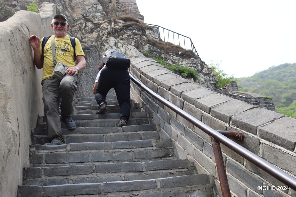 Climbing the Great Wall demands determination. Here, a tourist gracefully ascends the stairs at Juyongguan Great Wall with cat-like precision