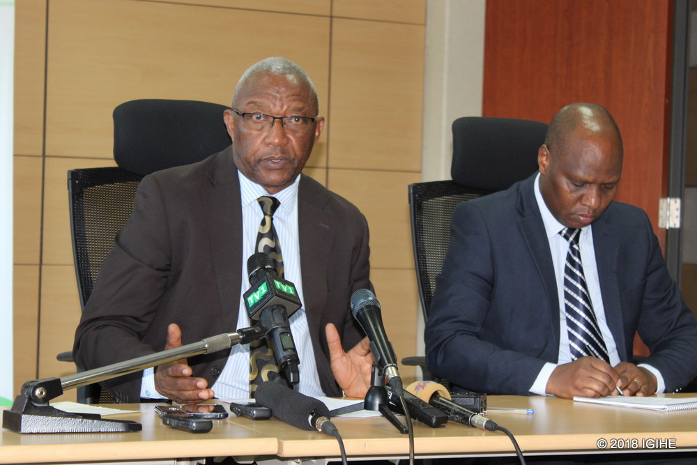 NEC Chairperson, Prof. Kalisa Mbanda speaks to the media as NEC Executive Secretary Charles Munyaneza looks on.
