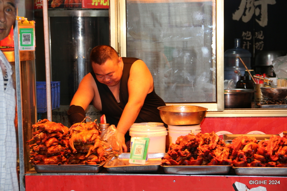 Shops offering a variety of goods, from groceries and local delicacies to cultural artifacts and souvenirs, line the street, attracting both locals and tourists.