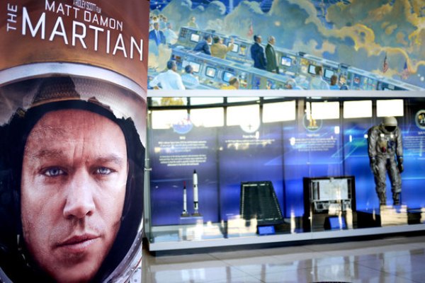 The Martian poster with astronaut Gus Grissom's space suit on display in the background at NASA's Johnson Space Center. Credit: Alejandro Rojas.